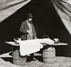 Embalming surgeon at work on soldier's body 1863