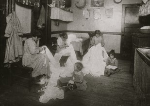 Embroidering chiffon waists in crowded bed-room, East Side. 1912
