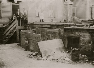 Entrance to the crowded, dirty house of a Midwife, rear tenement on Spruce Street, Providence, R.I. 1912