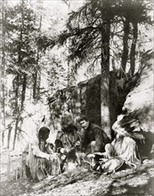 Ernest Thompson Seton, with three Blackfeet Indians, demonstrating how to start a fire 1917