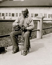 Ex-Slave - Man seated with pipe in 1920 1920