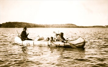 Five Ojibwa Indians: man, woman, and three children in canoe. 1913