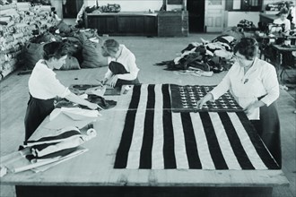 Flags laid out on cutting table to be sewn by Seamstresses who will make American ensigns during the period of the Great War 1917