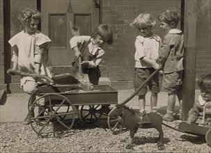Children Load stones in Wagon with Shovel 1915