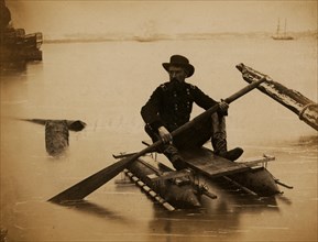 General Haupt rowing a boat made of a pair of small pontoons. 1863