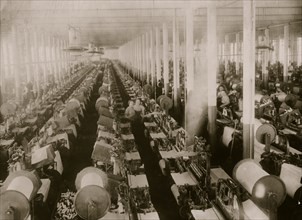 General view of weave room, Cornell Mill. Immediately after the photo was taken, the looms started up with deafening clatter. 1912