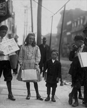 Girl and boys selling papers 1910