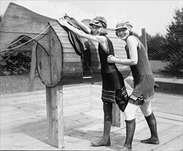 Girl is Helped by Friend to Mount a wooden Polo Dummy Horse 1921