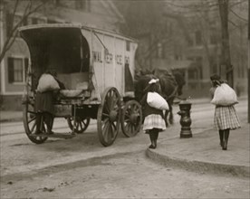 Girls working on ice wagon and delivering it in bags or sacks to homes 1912