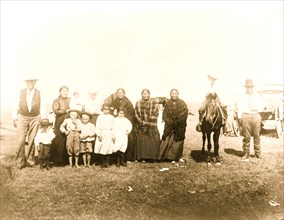 Group of Kickapoo Indians, standing outside tent, dressed in Euro-American clothing 1918