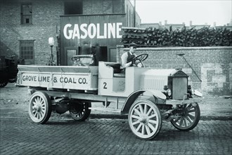 Grove Lime & Coal Company in front of a building sign that reads Gasoline 1925