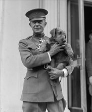Highly Decorated WWI Marine Corps Colonel Holds a dog endearingly 1923