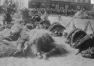 French soldiers in full pack bed down on straw after a long march 1918