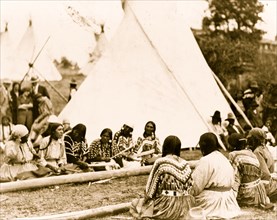Indian women playing the stick game at the midsummer celebration on the Glacier National Park Reservation, Montana 1925