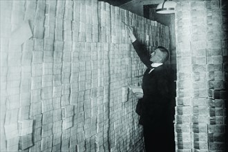 Inflation in Weimar Germany has paper money stacked from Floor to Ceiling in a Berlin Bank