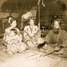 Interior of an Ainu home, showing owner and family, Yezo, Japan 1906