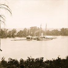 James River, Virginia. U.S. monitor CANONICUS taking on coal from a schooner 1864