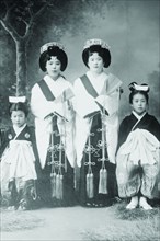 Japanese Mothers with Their Children wear traditional Kimono with Obi & hair combs