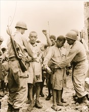 Japanese prisoners of war being guarded by Americans 1944