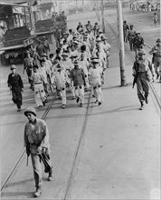 Japanese prisoners of war being guarded by Americans--probably in the Philippines 1944