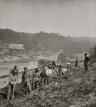 Jericho Mills, Va. Party of the 50th New York Engineers building a road on the south bank of the North Anna, with a general headquarters wagon train crossing the pontoon bridge 1864