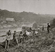 Jericho Mills, Va. Party of the 50th New York Engineers building a road on the south bank of the North Anna, with a general headquarters wagon train crossing the pontoon bridge 1864