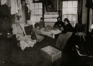 Julian, a six-year-old child, making pansies for her neighbors on top floor 1912