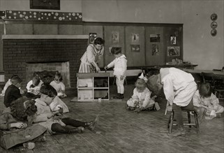 Kindergarten children in Horace Mann School working on doll houses 1917
