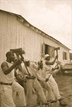 Lightning' Washington, an African American prisoner, singing with his group in the woodyard at Darlington State Farm, Texas 1934