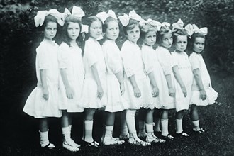 Line up of Beautiful Kindergartners in a row wearing white dresses 1913