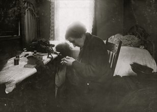 Making hair-goods in a tiny hall-bedroom. 1912