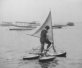 Man stands on Sail Driven water Tricycle 1915