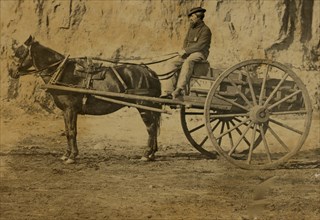 Man sitting in a horse drawn cart 1863