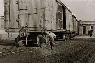 Boy beside a boxcar at the Mill 1908