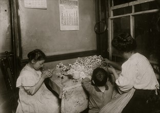 Family works making flowers in their tenement apartment 1911