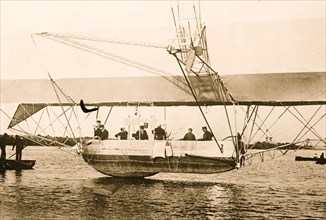 Men inside basket of Zeppelin airship, on water 1908