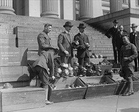Men unload Prussian Helmets  1919