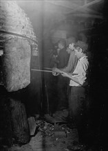 Midnight in a Glass Works in Grafton, W. Va. Boys at the "Glory-Hole" where object is reheated before going to finisher 1908