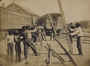 Military railroad operations in northern Virginia: men using levers for loosening rails 1863