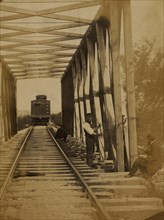Military railroad operations in northern Virginia: men working on bridge 1863