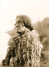 Mohave man wearing "primitive" robe of rabbit skin 1906