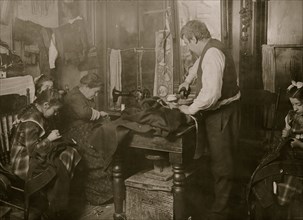 Italian family presses, tailors, sews in tenement apartment at night 1908