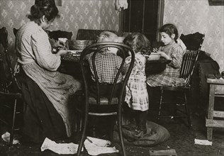 Italian Family picks nuts in their tenement apartment 1911