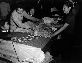 Mrs. Nakamura and family buying clothing 1943