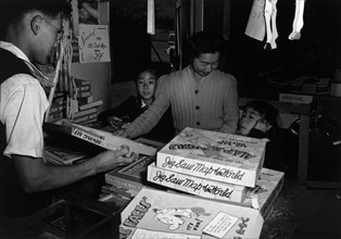 Mrs. Yaeko Nakamura and family buying toys with Fred Moriguchi 1943