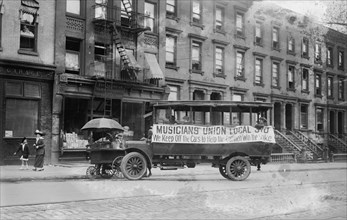 Musicians Union Truck parked by Hot Dog Vendor Cart sports large banner supporting the Transit Strike 1916