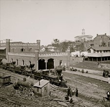 Nashville, Tenn. Railroad yard and depot with locomotives; the Capitol in distance 1864