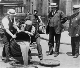 Pouring out illegal alcohol into a Sewer 1921