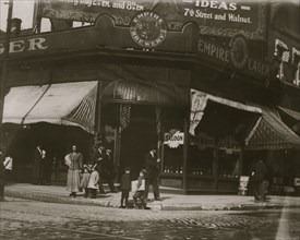 Newsies selling near saloon.  1910