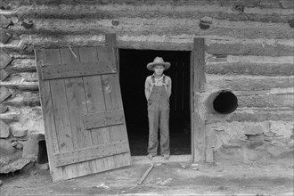Farm boy in doorway of tobacco barn 1939